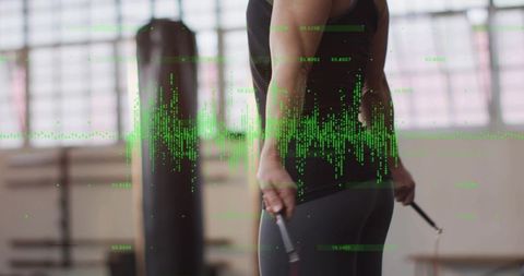Woman jumping rope in gym with green data overlay representing fitness analytics and cardio training