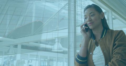 Businesswoman Analyzing Data While on Call in Modern Office