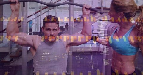 Man performing lat pulldown while woman spotting in gym with futuristic data overlay