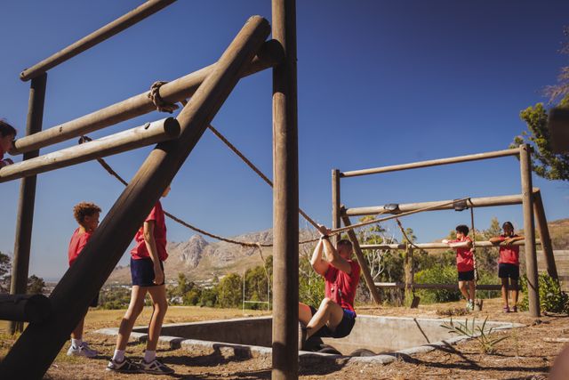 Trainer Assisting Kids in Obstacle Course Training at Boot Camp - Download Free Stock Photos Pikwizard.com