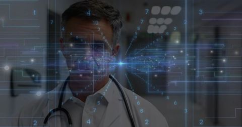 Standing doctor viewing augmented reality medical data in clinical corridor