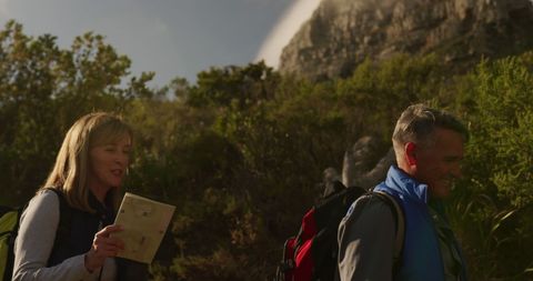 Senior Couple Hiking with Map in Scenic Nature Landscape