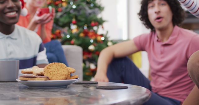 Friends Enjoying Holiday Cookies Near Christmas Tree - Download Free Stock Images Pikwizard.com