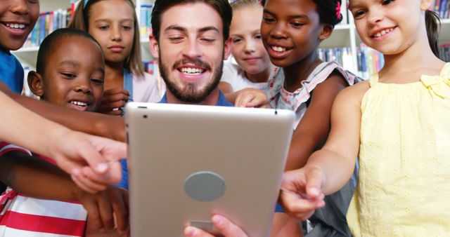 Teacher with Diverse Group of Children Using Tablet in Library - Download Free Stock Images Pikwizard.com