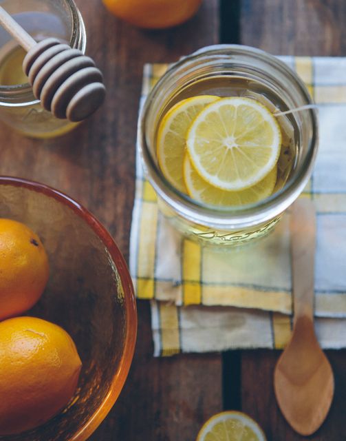Lemon slices and honey jar provide perfect combination of natural ingredients for health and wellness. Warm tones and rustic style enhance charm, ideal for organic, food blogging, and recipe content. Great for conveying fresh and homemade feelings.