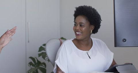 Smiling woman engaging in professional office discussion
