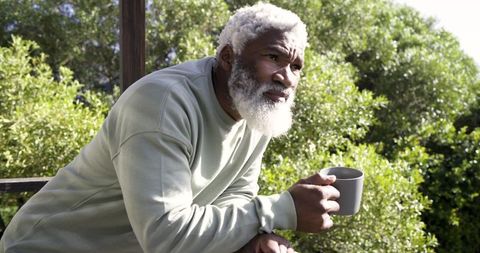 Mature Man Enjoying Tranquility with Coffee Outdoors