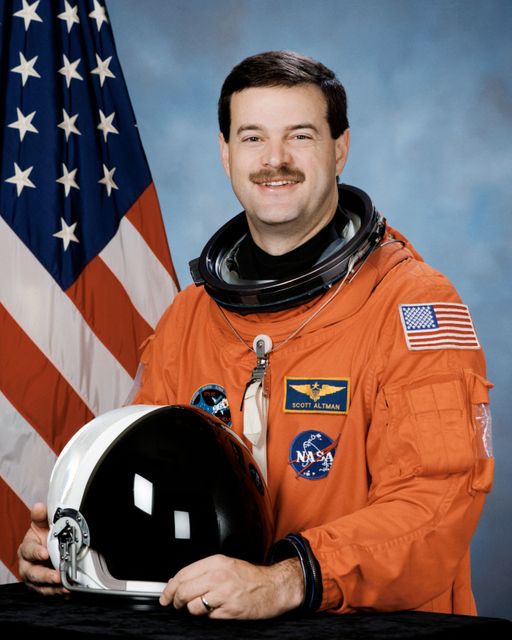 Astronaut holding a space helmet, standing before a US flag. Depicting space exploration and dedication. Ideal for educational materials, history lessons, space-focused articles, or promotional space programs.