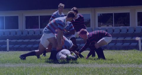 Intense rugby match with diverse players competing for ball
