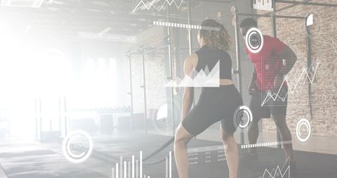 Backlit battle ropes training with trainer and performance analytics hud in industrial gym