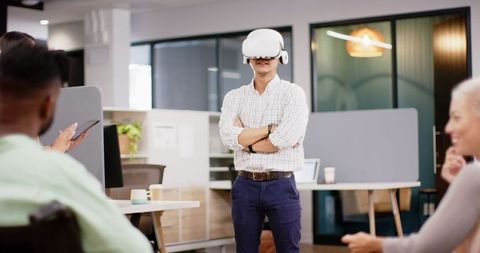 Businessman Using VR Headset in Modern Office Meeting