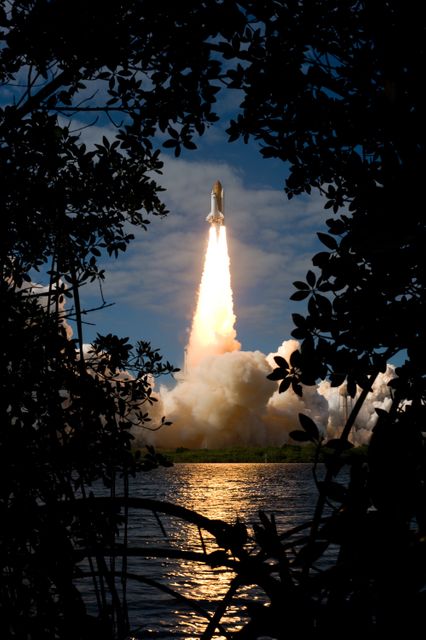 This powerful scene of the Space Shuttle Atlantis launching amidst dense tropical vegetation at Cape Canaveral captures the impressive engineering feat and sense of wonder associated with space exploration. Ideal for use in educational materials, space exploration documentaries, technology showcases, and inspiring posters. It also emphasizes themes of science, progress, and human achievements in aerospace industry.