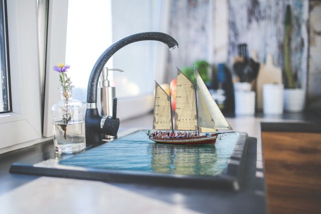 Boat in the vessel sink on countertop in bathroom. Modern home architecture and interior concept