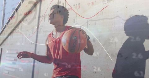 Athletic man holding basketball with financial chart overlay