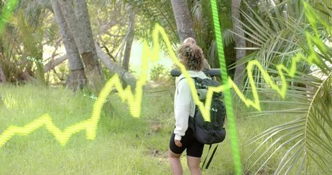 Hiker Exploring Tropical Palm Trail with Backpack, Rolled Mat and Neon Data Graph Overlay