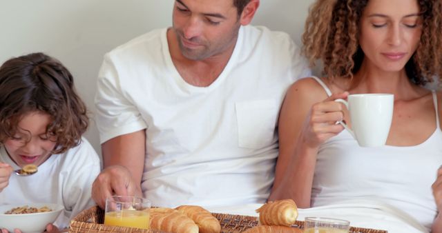 Family Enjoying Breakfast in Bed with Croissants and Cereal - Download Free Stock Images Pikwizard.com