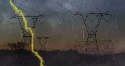 Lightning strikes during storm over power lines indicating climate challenge
