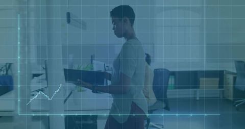 Walking businesswoman holding binder in open-plan office with data analytics overlay