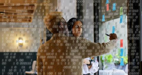 Professionals Brainstorming on Glass Board in Modern Office