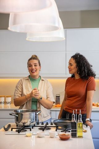 Diverse Female Friends Preparing Meal in Modern Kitchen