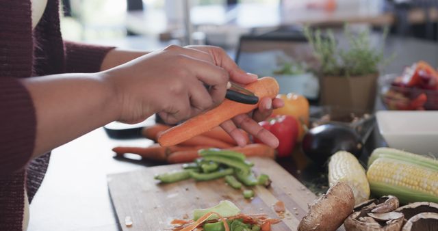 Hands Peeling Fresh Carrot in Modern Kitchen - Download Free Stock Images Pikwizard.com