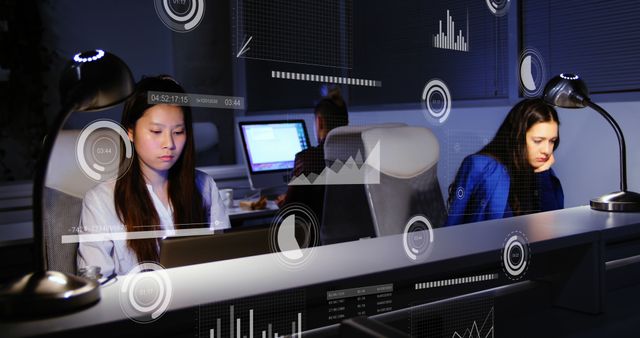 Women engage in late-night work in an advanced office environment. They focus on their tasks, surrounded by virtual data visualizations such as graphs and charts. Ideal for illustrating topics related to technology, teamwork, advanced analytics, digital innovation, night shifts, and modern workplaces.