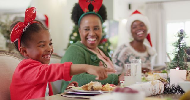 Happy african american family having christmas dinner. Spending quality time with family at home concept.