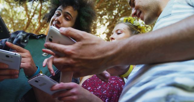 Diverse friends interacting with smartphones outdoors in summer - Download Free Stock Images Pikwizard.com