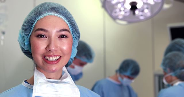 Smiling Female Surgeon in Operating Room with Team - Download Free Stock Images Pikwizard.com