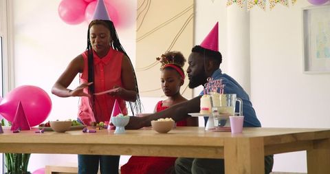 Family Celebrating Young Girl's Birthday with Festive Decorations