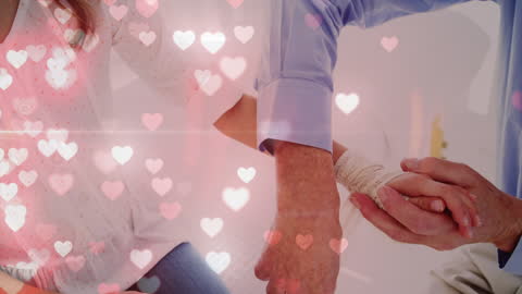 Hands Wrapping Arm in Warm Heart Background