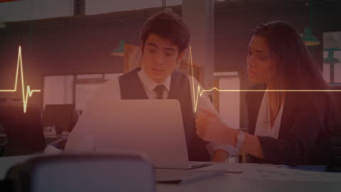 Business Partners Analyzing Data with Digital Monitor Overlay