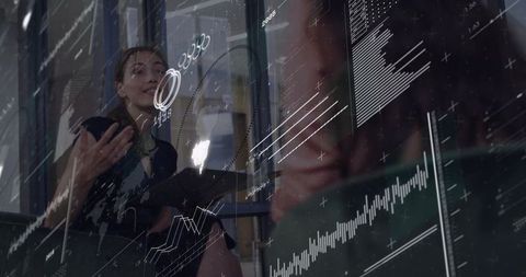 Businesswomen Collaborating with Data Visualization Overlay