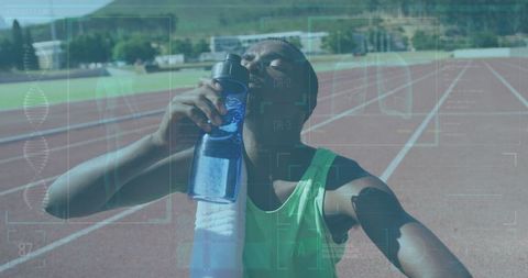 Teenage Athlete Hydrating on Running Track