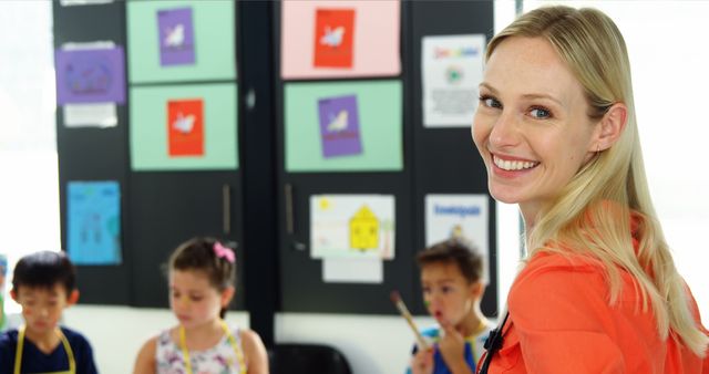 Smiling Teacher Interacting with Young Students in Classroom - Download Free Stock Images Pikwizard.com