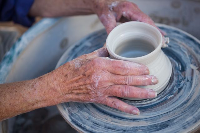 Close-up of potter making pot in pottery workshop