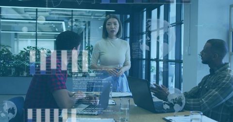 Asian Female Executive Presenting in Modern Office with Innovative Charts