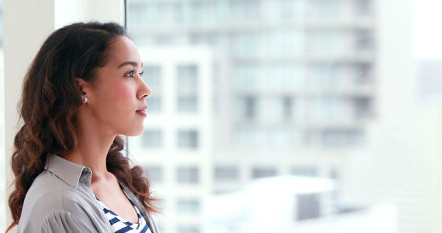 Thoughtful Woman Looking Out Window in Urban Setting - Download Free Stock Images Pikwizard.com