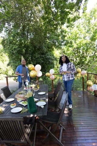 African american friends celebrating outdoors with decorations