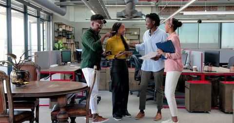 Diverse Team Collaborating Enthusiastically in Modern Office Space