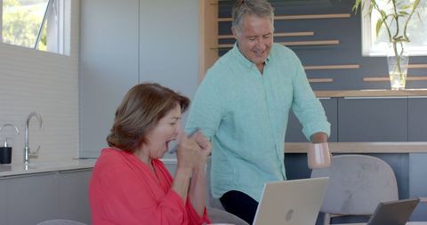Senior Couple Celebrating Technology Success at Home