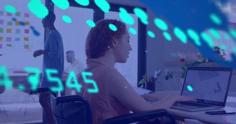 Businesswoman in wheelchair analyzing financial data in modern office