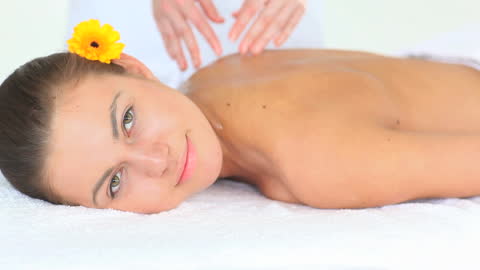Relaxed Woman Enjoying Massage in Tranquil Spa