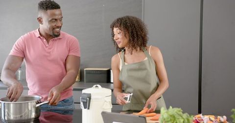 Couple Enjoys Cooking Together in Modern Kitchen Setting