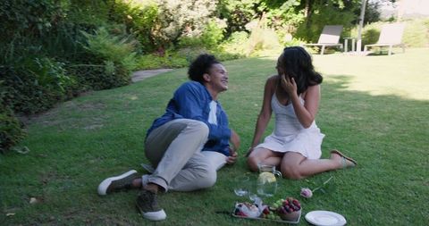 Couple Enjoying Romantic Picnic in Sunny Garden