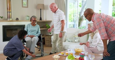 Seniors Relaxing and Assisting Each Other at Home Social Gathering