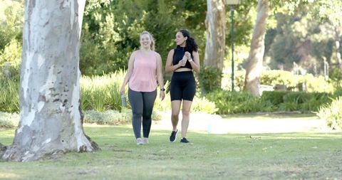 Diverse Friends Enjoying Walk in Captioned Park Setting