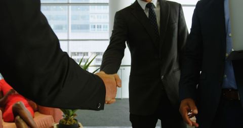 Two Businessmen Shaking Hands Sealing Partnership Deal - Download Free Stock Images Pikwizard.com