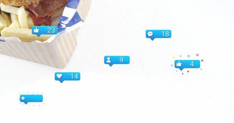 Displaying fast food takeout box holding burger and fries with social media like bubbles