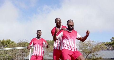 Joyful Soccer Players Celebrating Victory on Field